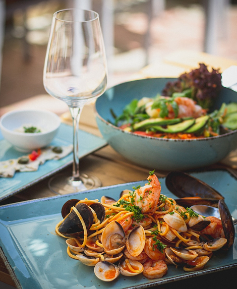 Elegant plated wedding cuisine with glassware and salad